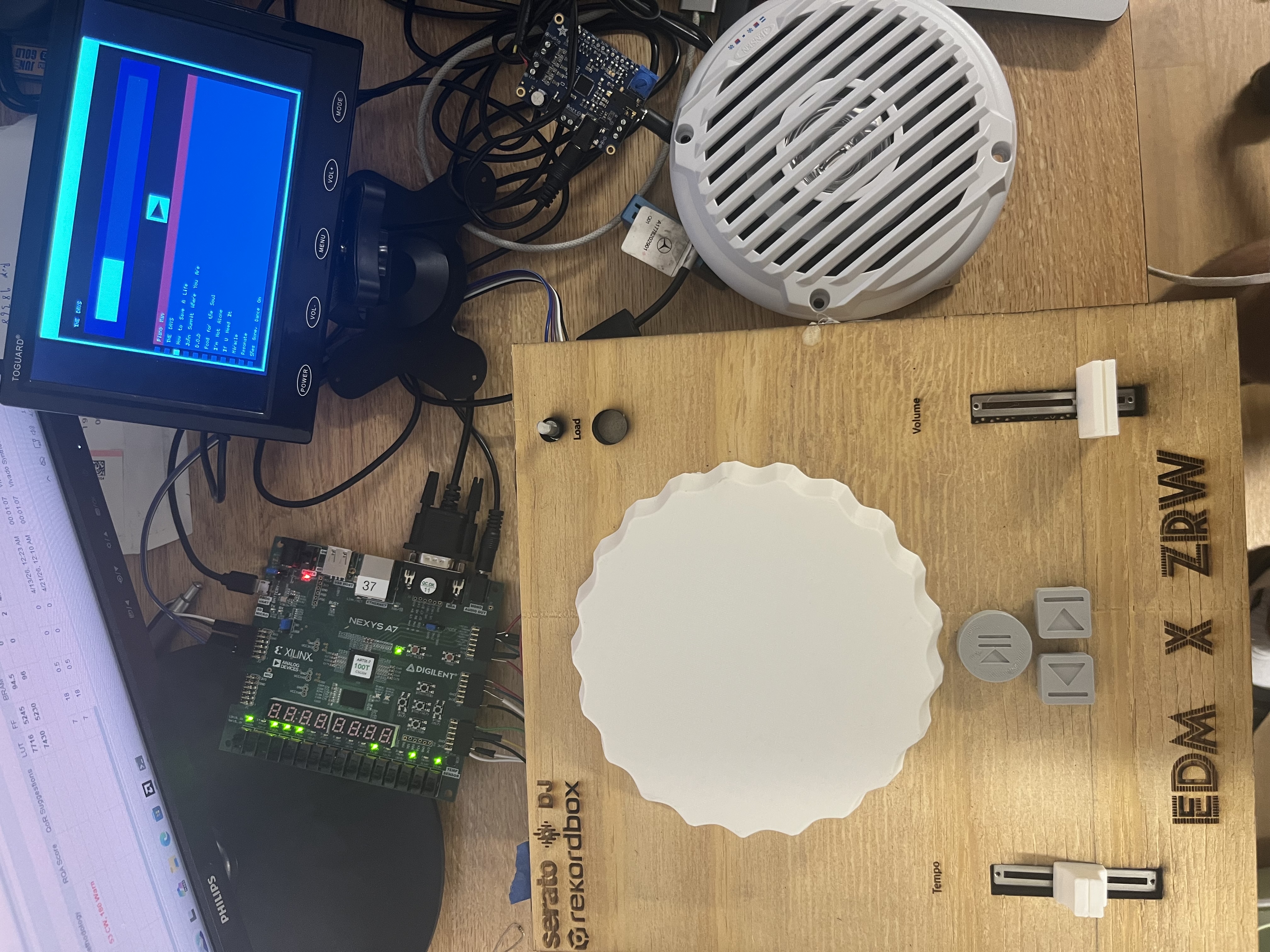 Custom-built FPGA DJ board with turntable, sliders, and Nexys A7 board